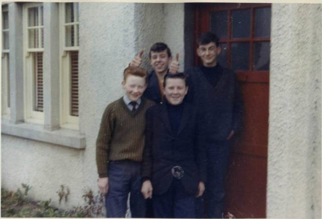 Four young lads heading off to play on the swings